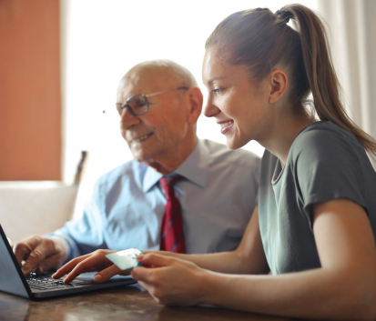 https://www.pexels.com/photo/young-woman-helping-senior-man-with-payment-on-internet-using-laptop-3823488/