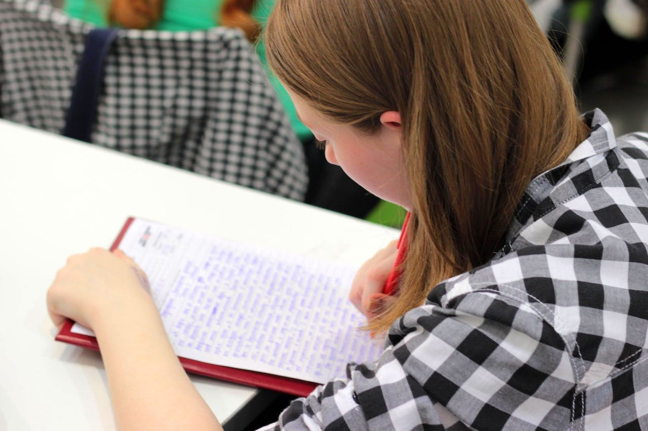 a woman taking down notes and finishing her goals