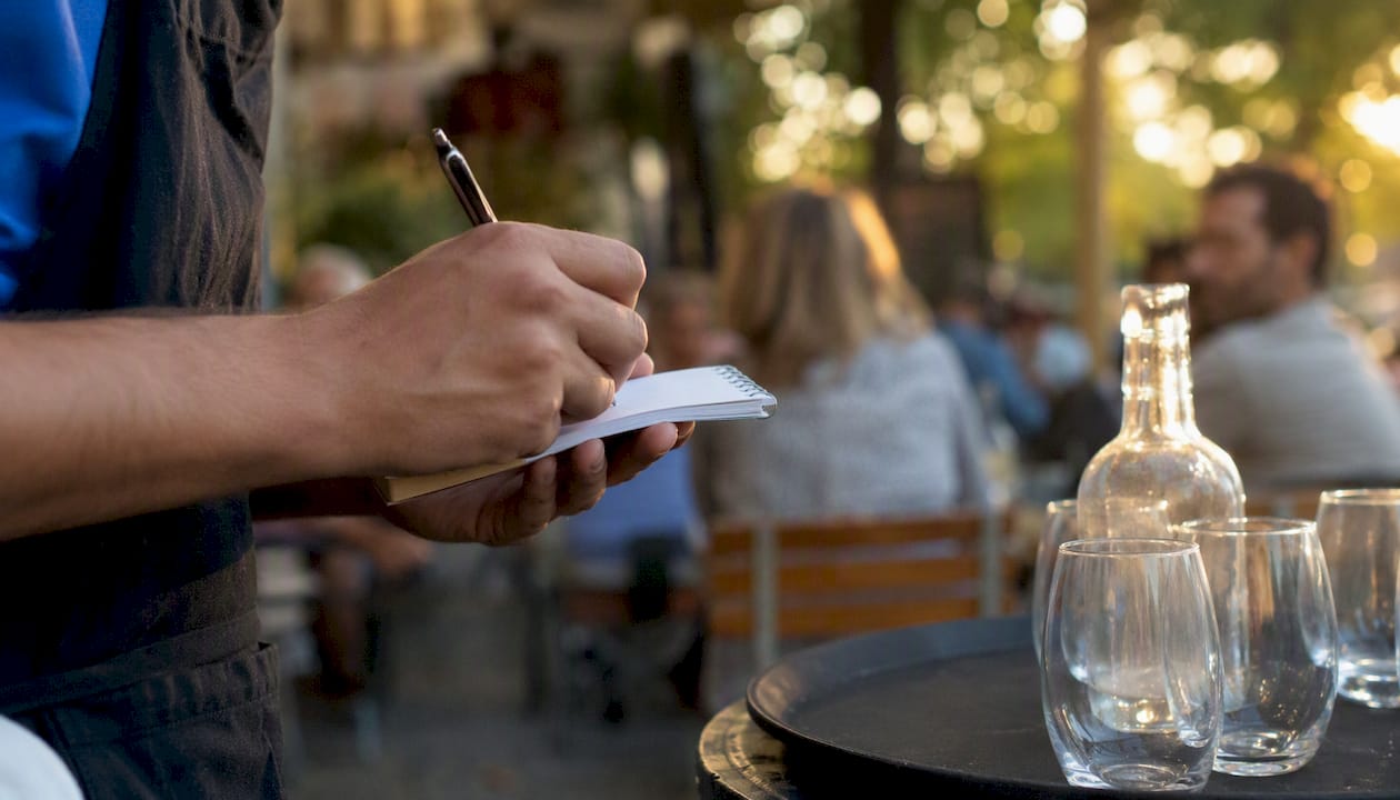 Waiter’s hand writing order
